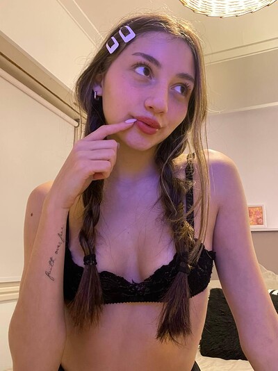 Kiera Brooks's finger teasing her lips, her black lace bra hinting at her wet, eager pussy below.