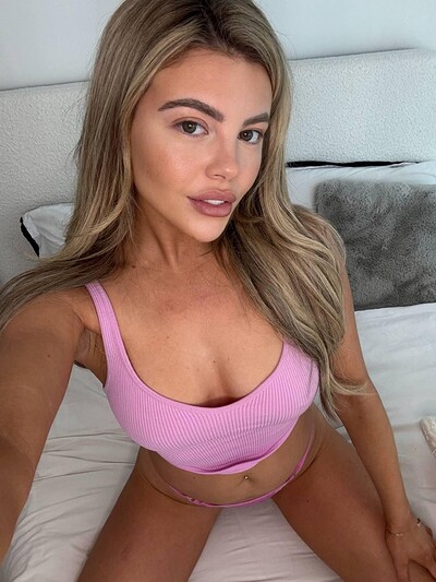 Tilly Harrington's pink bra is teasing her nipples, her lips slightly parted in anticipation.