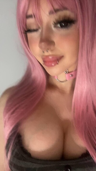 Mimi's plump lips are parted, her pink hair cascading as she teases with her cleavage, feeling so sexy.