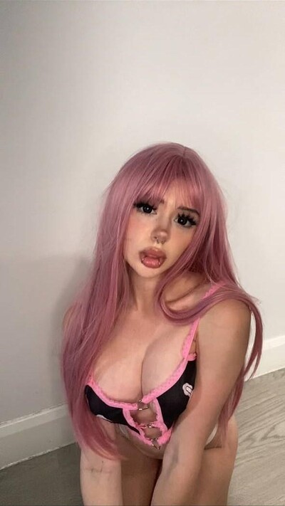 Mimi's pink hair frames her cleavage, her tongue teasingly out, craving your touch.