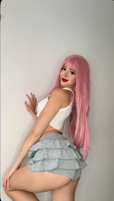 Mimi's pink hair teasing, her ass in ruffled gray shorts, ready to take it all off.