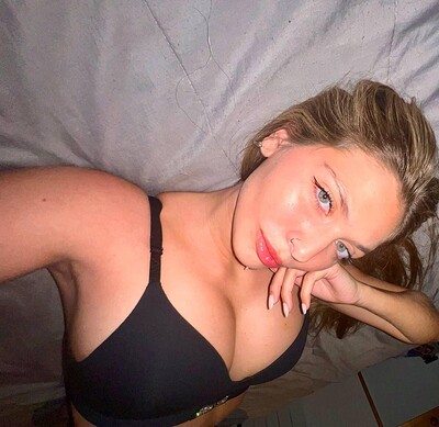 Grace Whitely's plump lips are slightly parted, anticipating a kiss, her hand resting seductively on her cheek.
