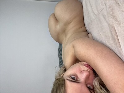 Ellie Rose's curvy ass is arched, her eyes half-lidded, anticipating a sensual touch.